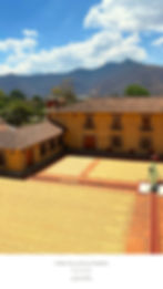 Yellow building with browns roofs next to coffee drying area. Mountains and blue sky in background. Text: Coffee Tour at Finca Filadelfia.