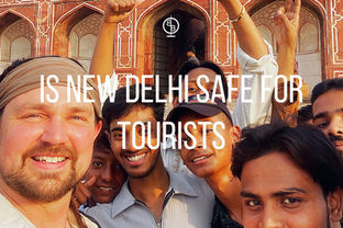 A group of smiling people taking a selfie in front of a red building in New Delhi. Text reads "Is New Delhi Safe for Tourists."