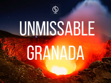 Glowing volcanic crater under night sky with text "Unmissable Granada." Fiery red and orange hues create a dramatic, captivating scene.