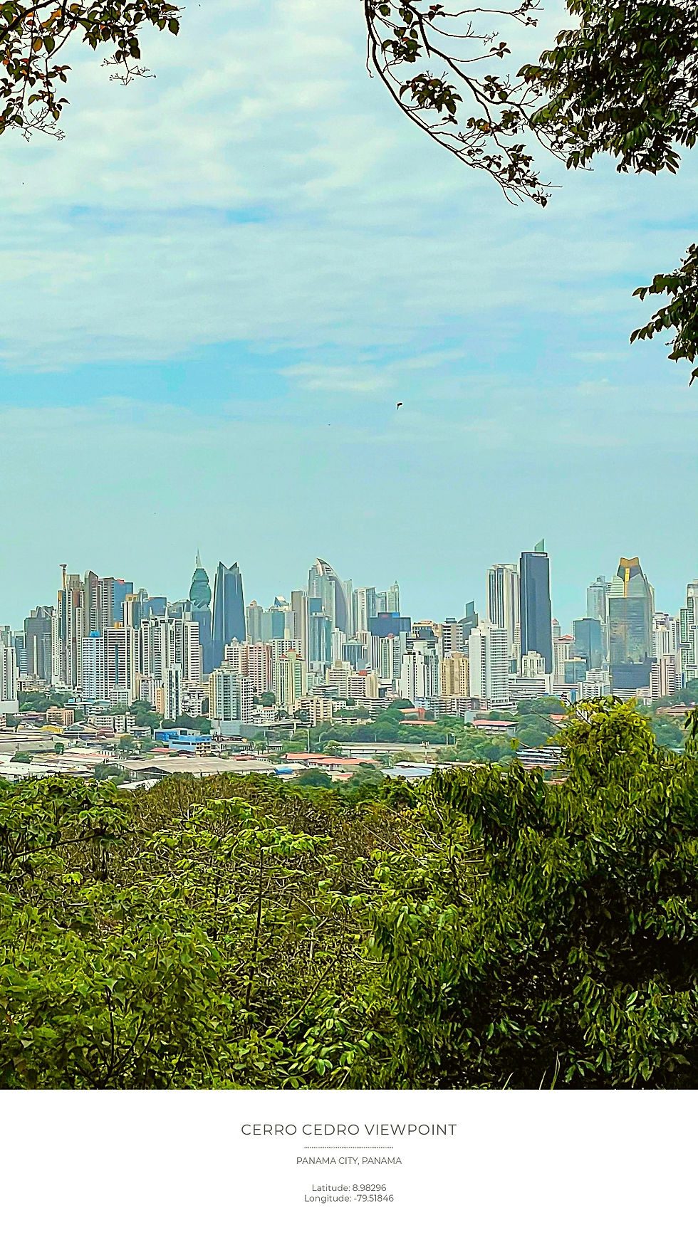 City skyline from Cerro Cedro Viewpoint, Panama City. Lush green foreground, clear blue sky. Coordinates noted at bottom.