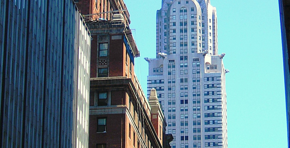 Chrysler Building against a clear blue sky, surrounded by other tall buildings. Text: "CHRYSLER BUILDING, NEW YORK, AMERICA, Lat: 40.75162, Lon: -73.9755".