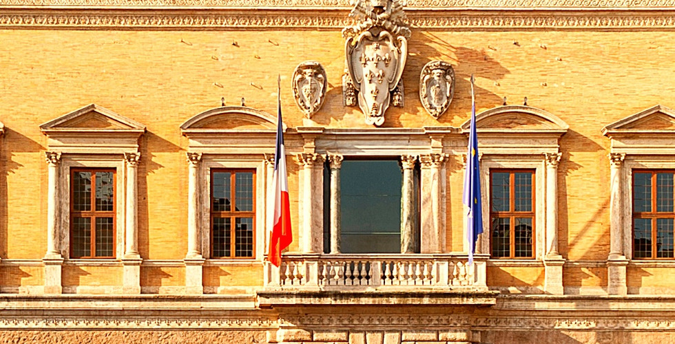 Palazzo Farnese, Rome, with light brown facade and arched windows against a clear blue sky. Text at bottom shows latitude and longitude.