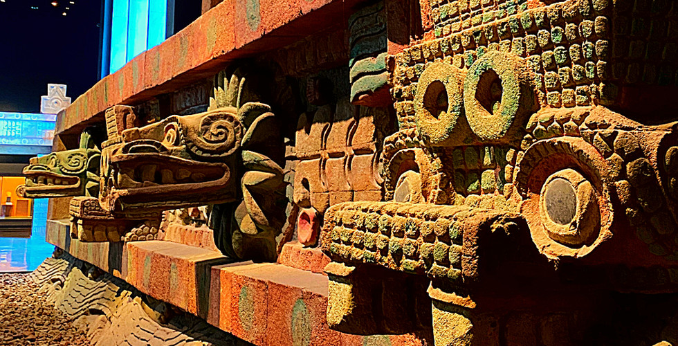 Colorful Tenochtitlan reconstruction at Museo Nacional de Antropología, Mexico. Intricate carvings, bright lights, and patterned ceiling.