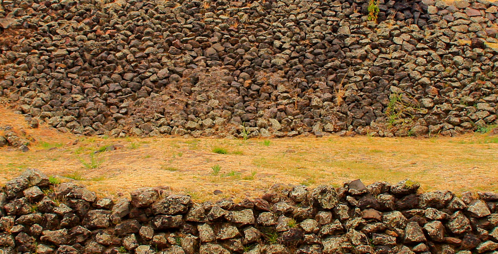 Stone structure at Cuicuilco, Mexico City, with tiered rock walls. Sparse grass surrounds. Text below shows location and coordinates.