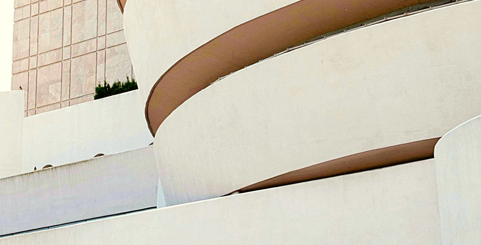 Guggenheim Museum's curved, cream exterior and text "SOLOMON R. GUGGENHEIM MUSEUM, NEW YORK" with location coordinates below.