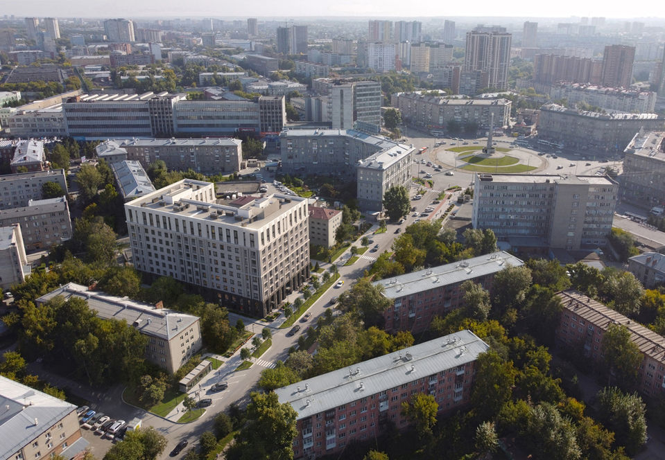 Aerial architectural visualization of a new residential development integrated into an existing urban environment, drone perspective exterior rendering, high-end site planning and master plan concept
