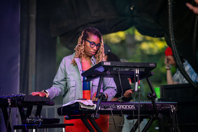 a woman playing the keyboard on stage at the Lilac Festival