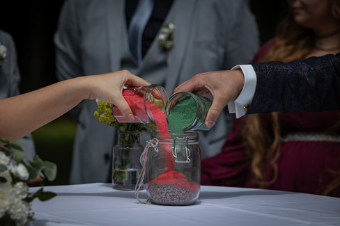 roter Sand, grüner Sand, werden in Glas geschüttet