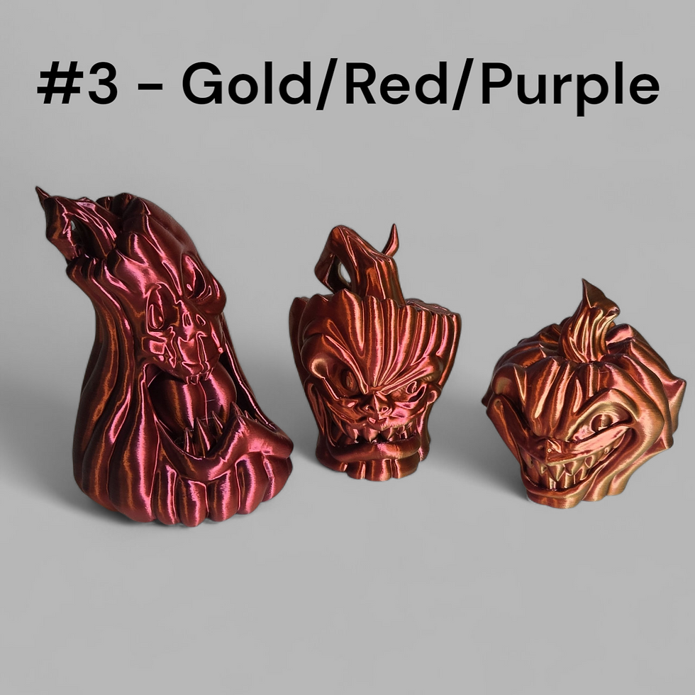Trio of stylized pumpkin figurines with monster faces and metallic finish