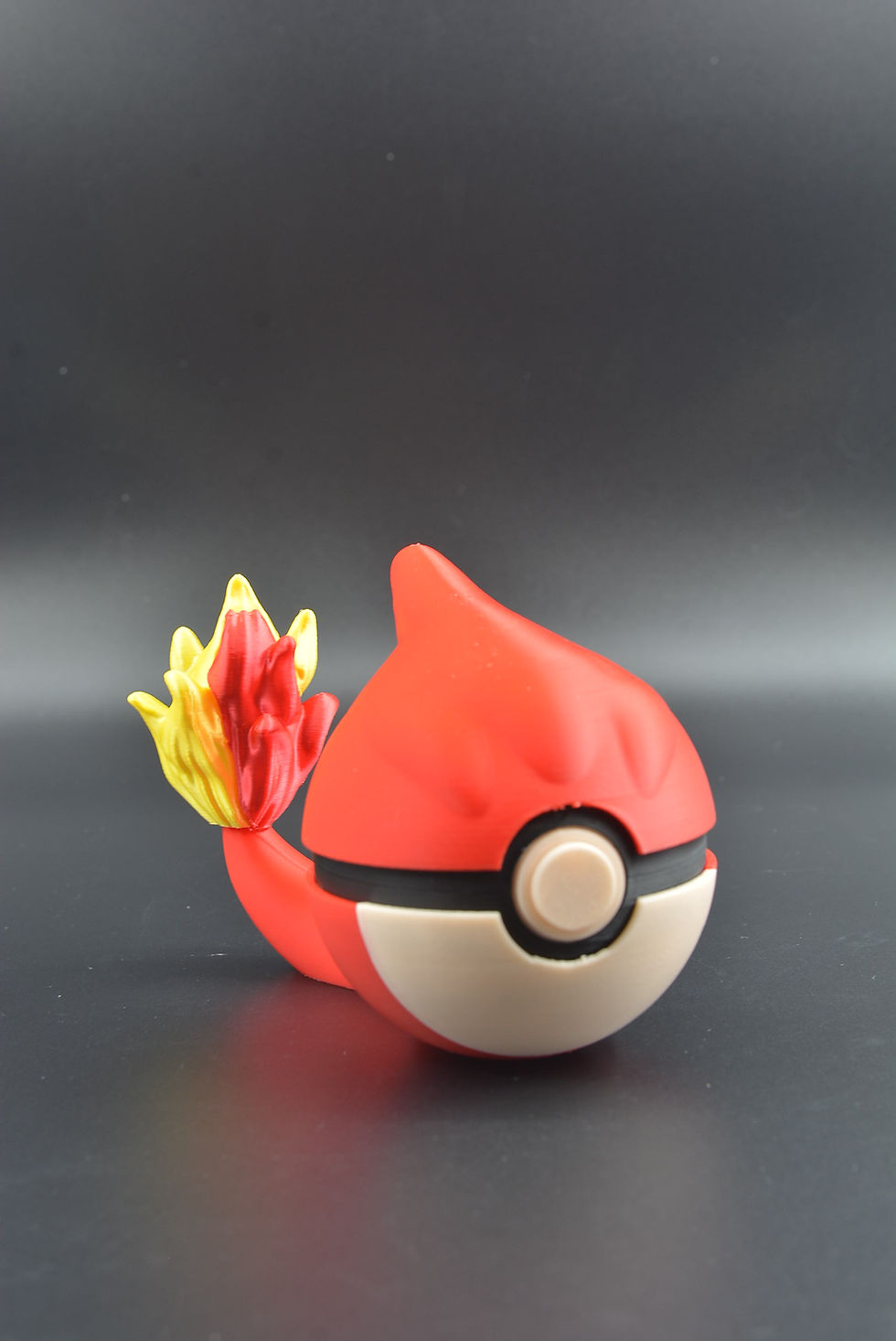 Charmeleon‑themed 3D printed character ball that opens to hold 13 Switch games and SD cards.