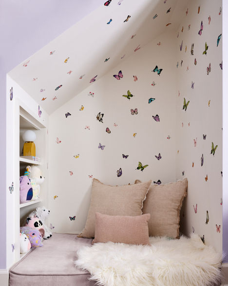 Girls’ bedroom with butterfly wallpaper and soft blush accents