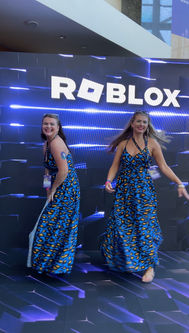 Sugarcoated Sisters posing at the Roblox event at VidCon Los Angeles in matching blue dresses.