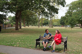 Two people on a bench in a park