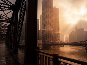Chicago skyline viewed from a bridge at golden hour with dramatic clouds.