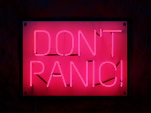 Pink neon sign reading “Don’t Panic” for an Illinois parenting emergency blog post