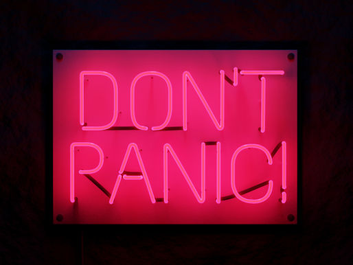 Pink neon sign reading “Don’t Panic” for an Illinois parenting emergency blog post