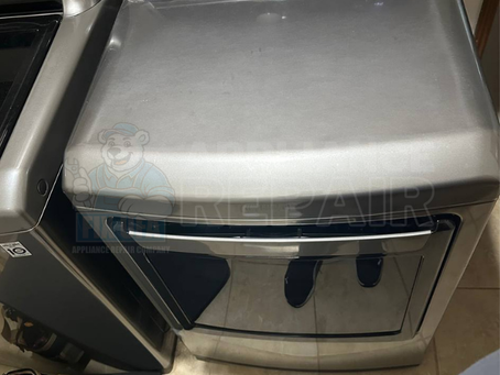 Silver washing machine in a laundry room with visible control panel. Text overlay: "Appliance Repair" and "www.fixufa.com."