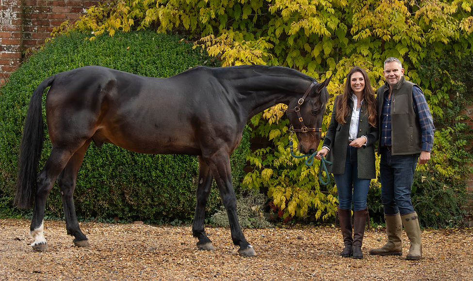 Couple with their magnificent horse at home taken by Belinda Dix Photography