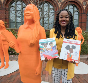 Dr. Simon with her statue holding her books