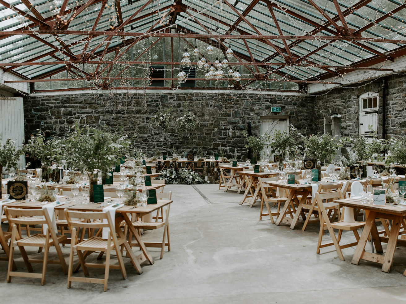 Barn decorated with greenery for a wedding.