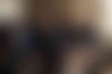 4 Groomsmen in kilts sitting watching the wedding ceremony with the wedding guests behind them, everyone is wearing black masks.