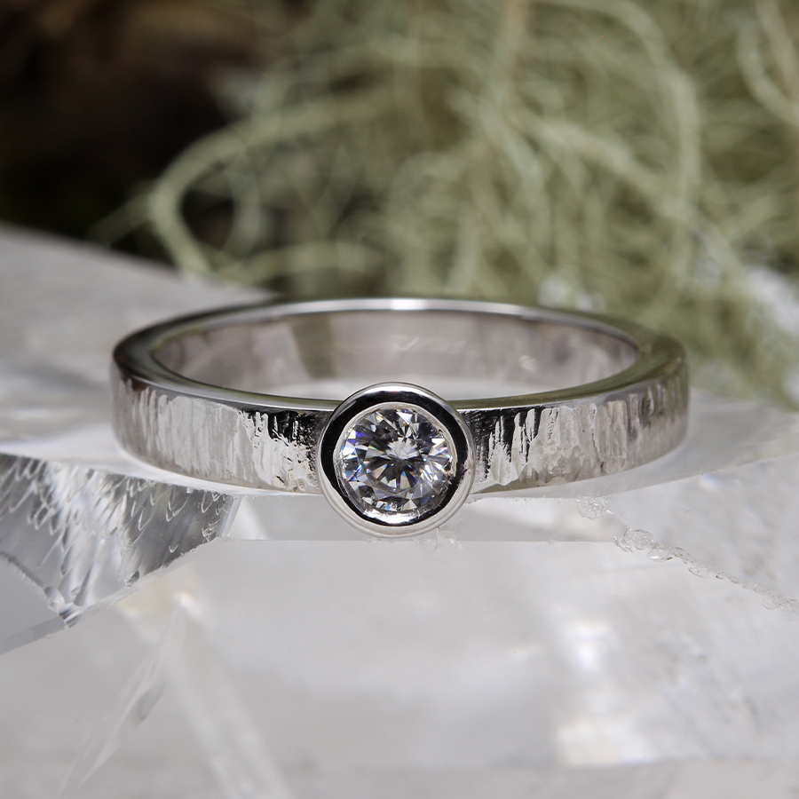 A silver ring with a diamond.