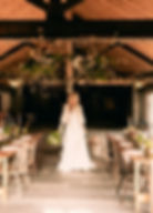 Bride standing in her wedding barn.