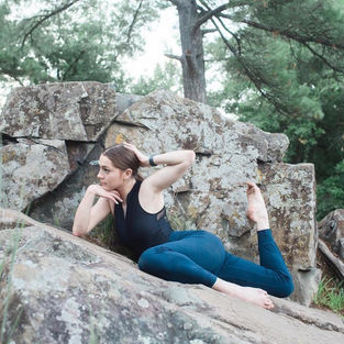 Double attitude pose laying down on rock at Taylor's Fall in Minnesota. 