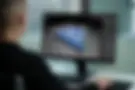 Firefly_over the shoulder shot of a man working at a computer designing in a black sweater