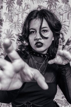 Black and white portrait of a woman reaching toward camera