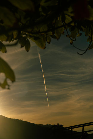 Jet stream across the sky, a beautiful sunset, nature, and the landscape view.