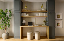 Home office with desk, laptop, books, and decor, Camila Interiors design.