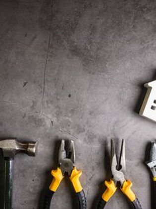 135353764-wooden-house-and-construction-tools-on-stone-pattern-background-with-copy-space-
