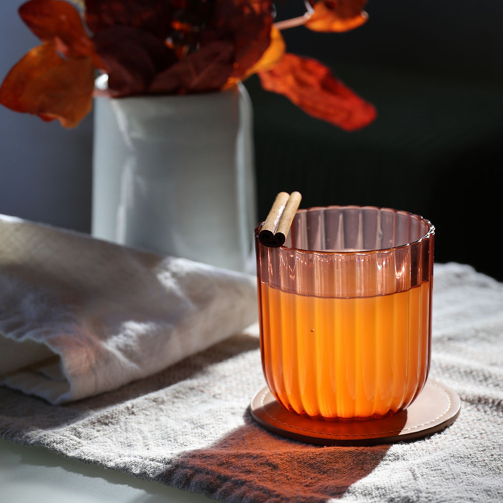 Spiked Apple Cider cocktail on table with cinnamon stick.
