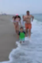 The Legg family running on the beach