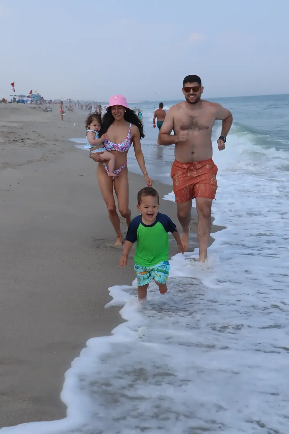 The Legg family running on the beach