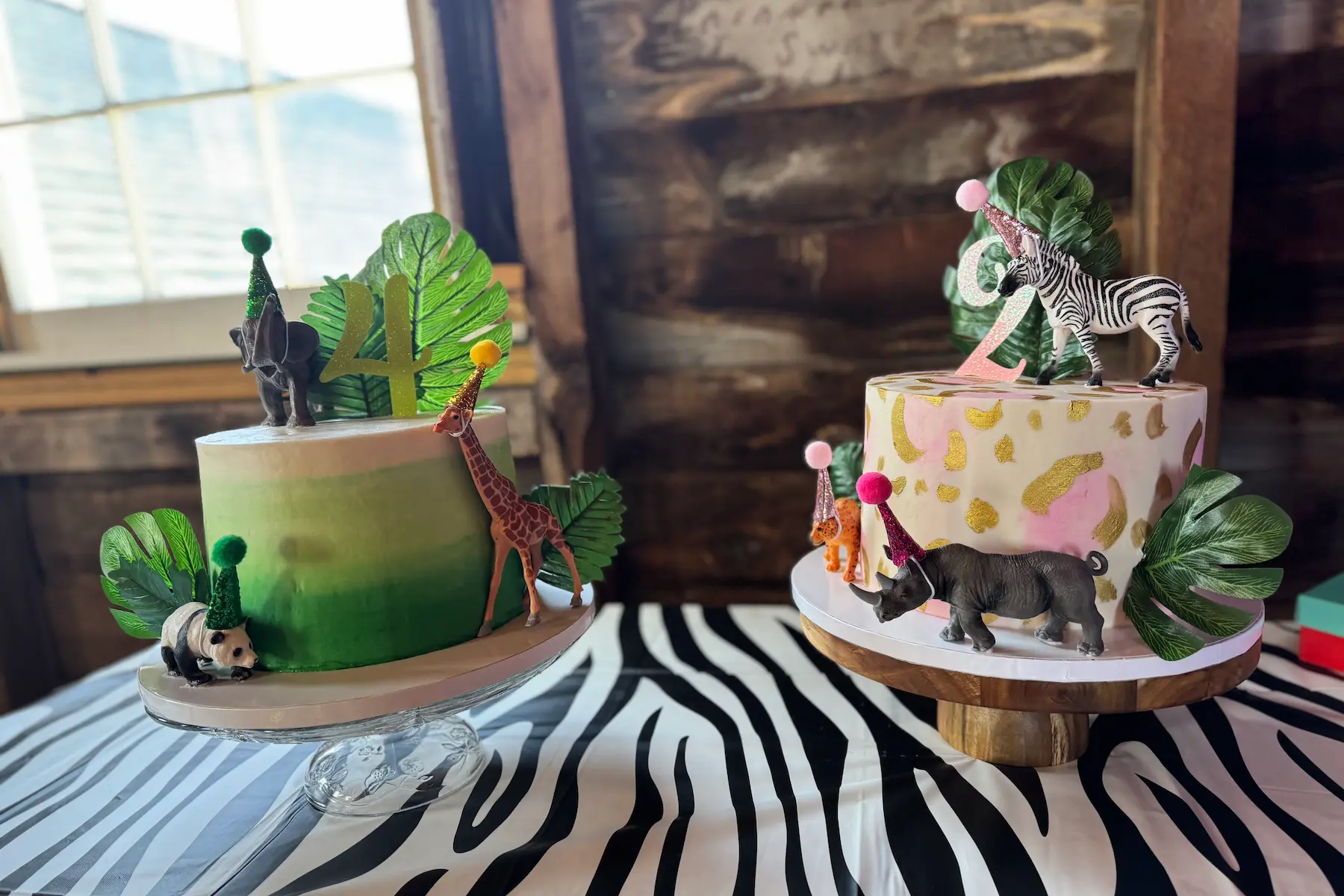 two animal themed cakes on a table