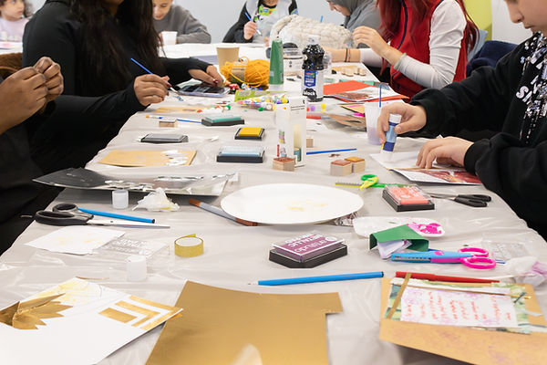 Hands creating handmade cards during a Kaiimages creative workshop