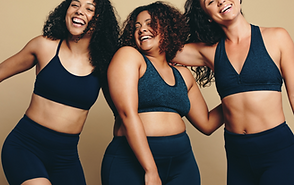 Three young adult women, smiling with ha