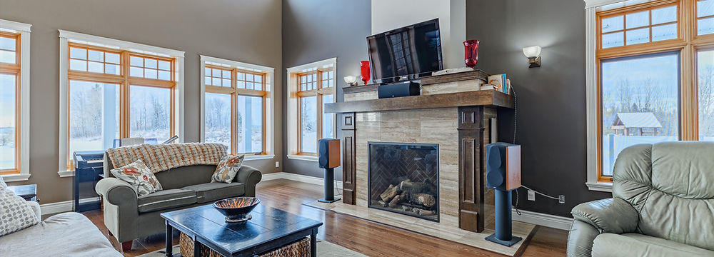 fireplace, huge windows, wooden floors in living room