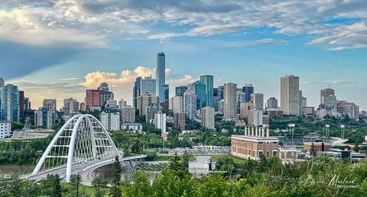 City of Edmonton, Walterdale Bridge in the foreground and the towers of Edmonton in behind.  Sunny skies with drifting clouds, real estate photography by curb appeal photography
