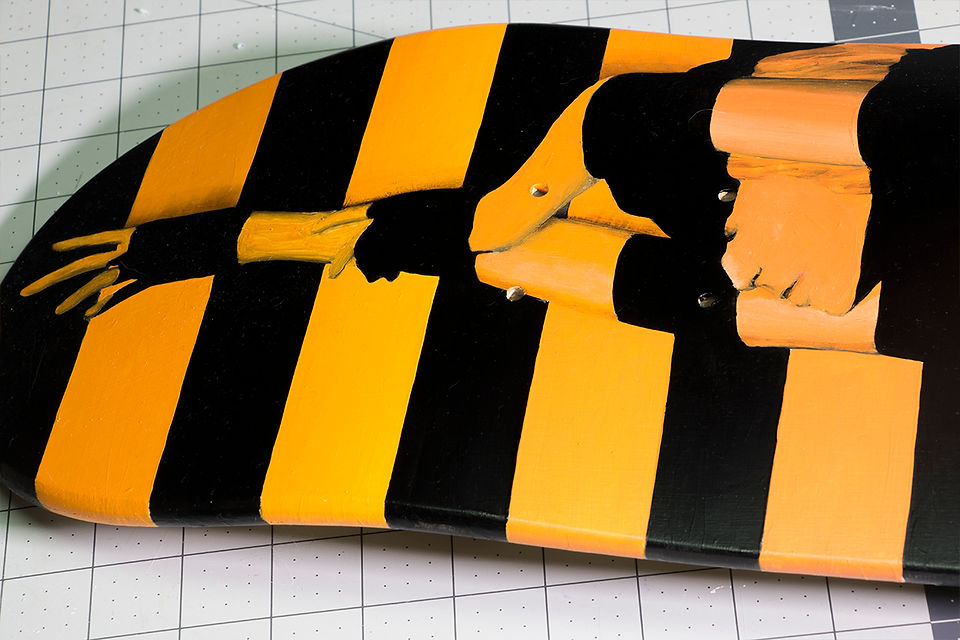 Divided by Night SK8 by Shane Turner Art Close up. Stripe painting of woman on skateboard.