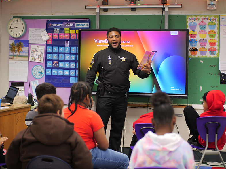 Sheriff Hash in class with children.jpg