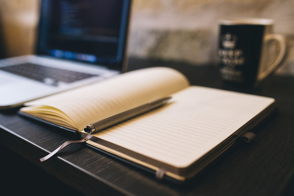 an open notebook and a laptop for website copy