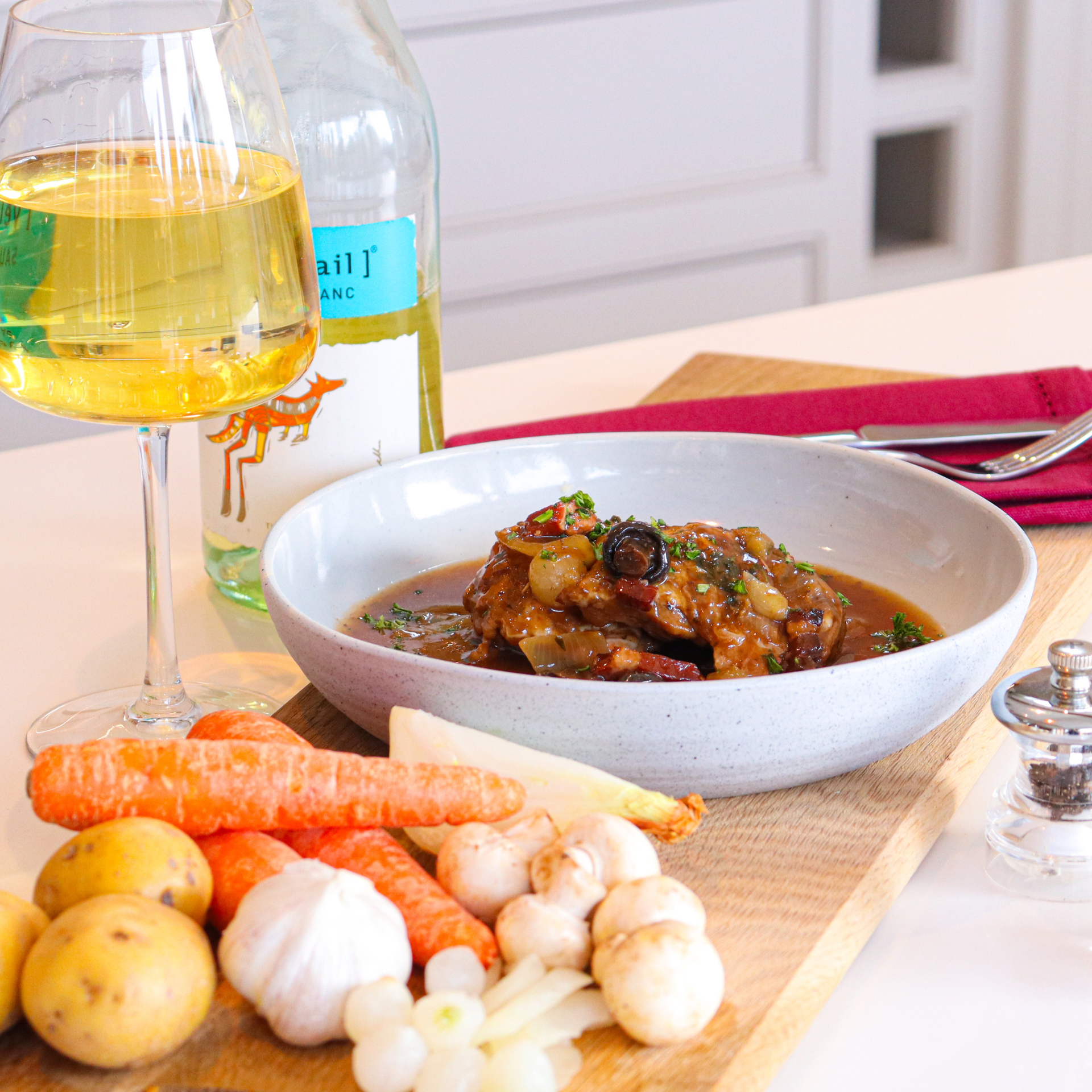 Sourced Meals Coq Au Vin in a white bowl with potatoes, carrots, garlic and white wine