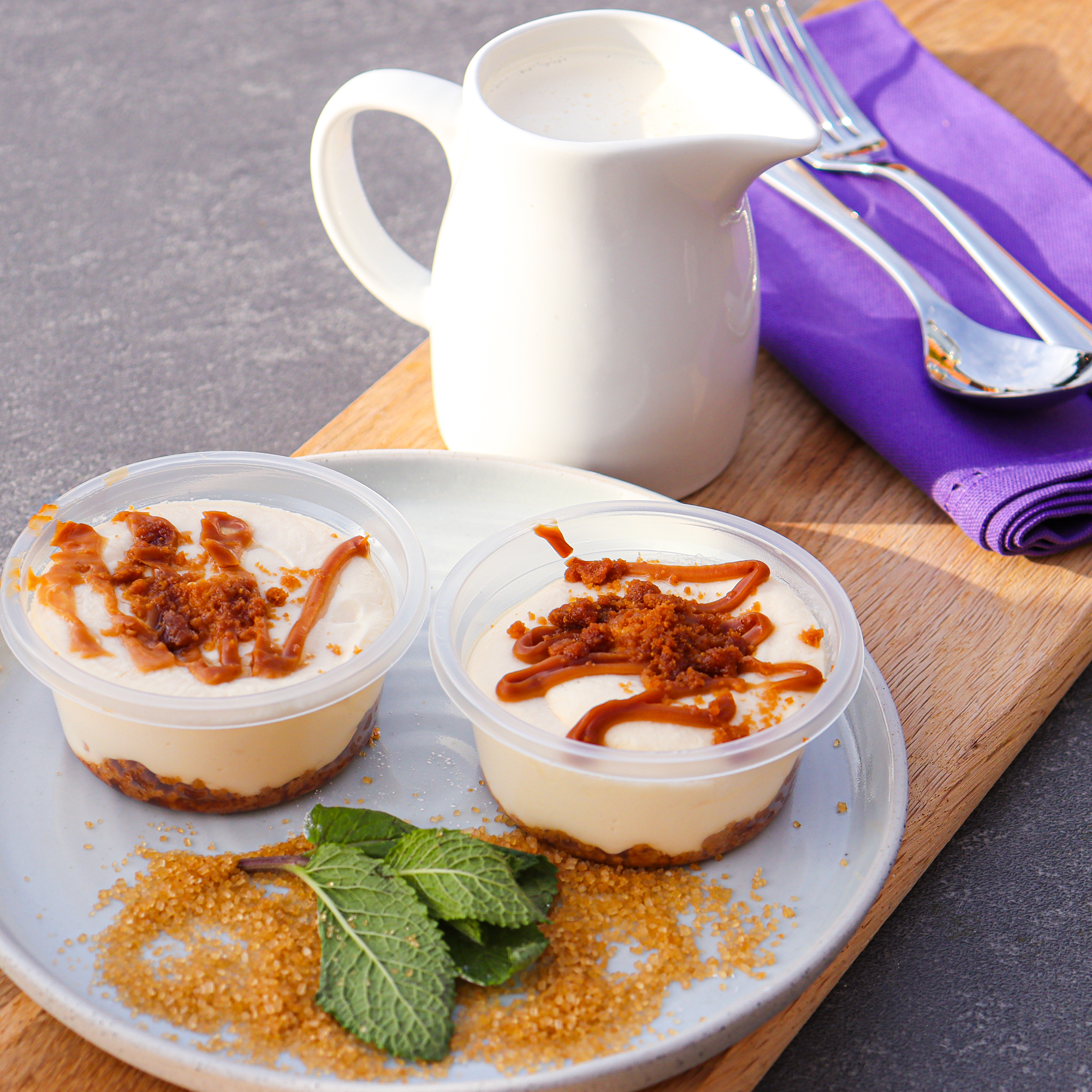 Close-up of two Biscoff cheesecakes topped with caramelised biscuit
