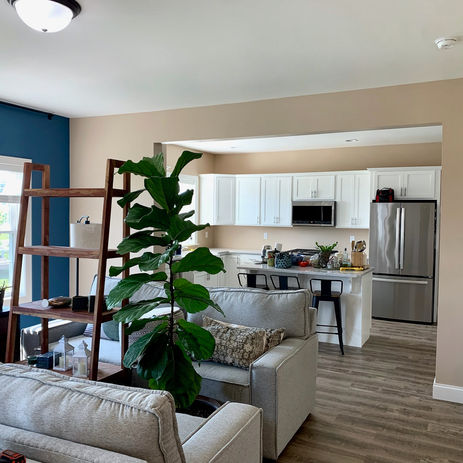 Living room with miscellaneous items and blue accent wall. 