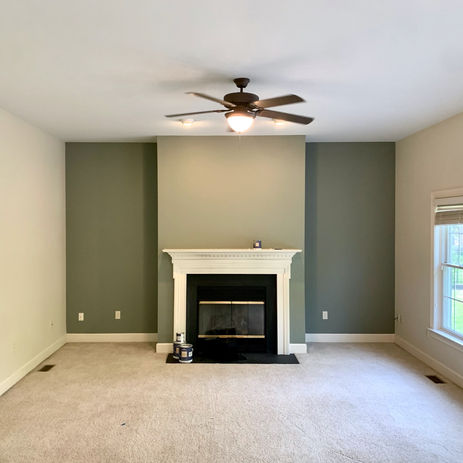 Green accent wall with white fireplace