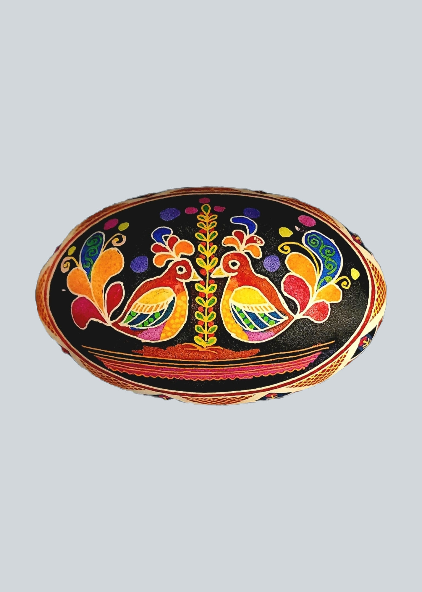 goose eggshell with two multicolor birds facing a leafy stalk on a black background