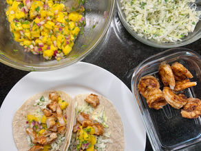 Assembling shrimp tacos with mango salsa and cilantro-lime slaw